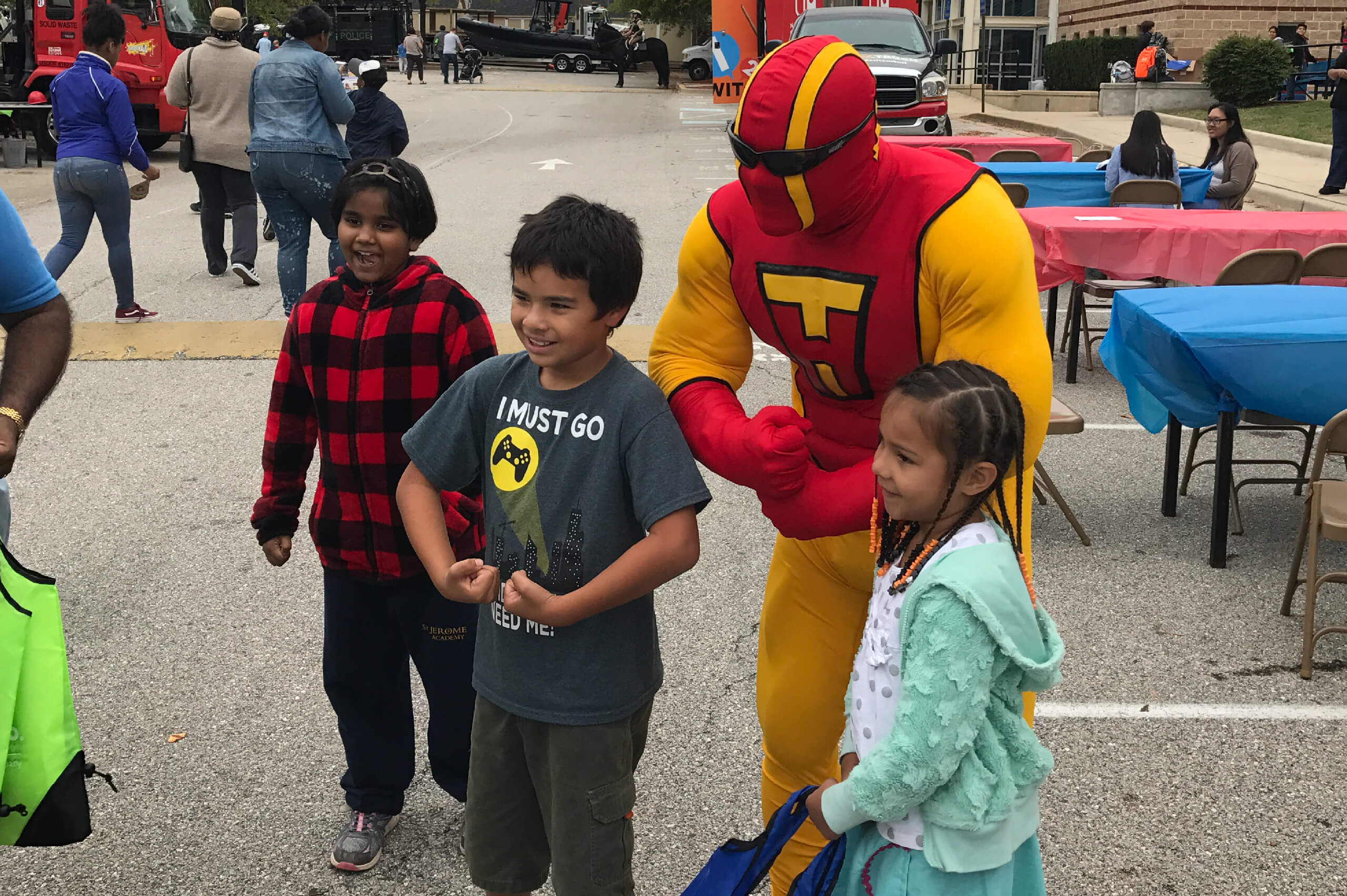TurboHaul Man flexes his muscles with kids in Laurel, MD