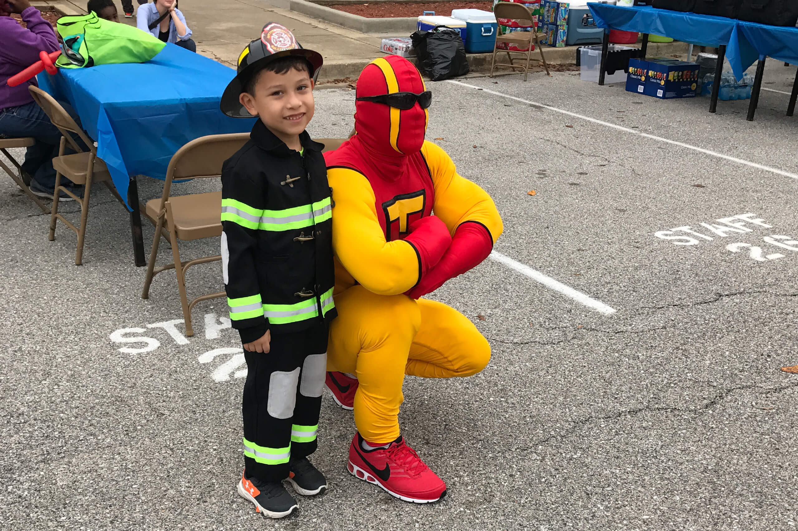 TurboMan stands with a young Montgomery, MD residents during a bulk trash hauling and junk removal event