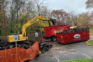 Heavy machinery moving bulk trash into one of TurboHaul's dumpsters during a Springfield, VA junk removal job.