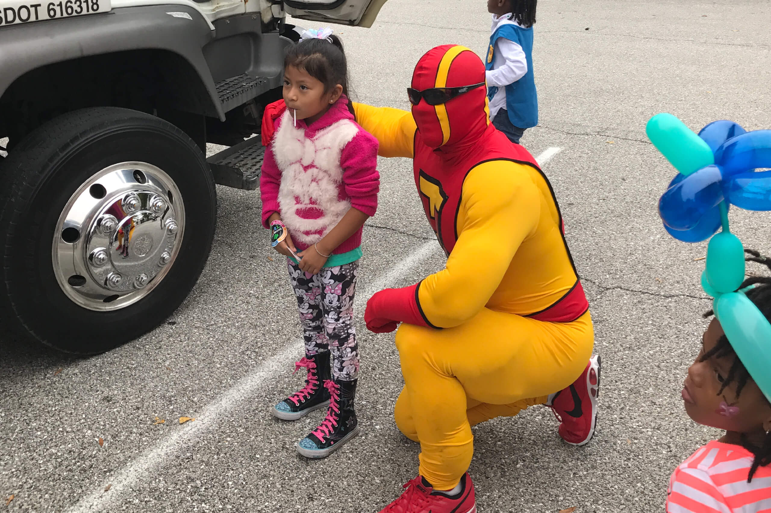 TurboMan poses with a young Odenton, Maryland resident during bulk trash hauling event.