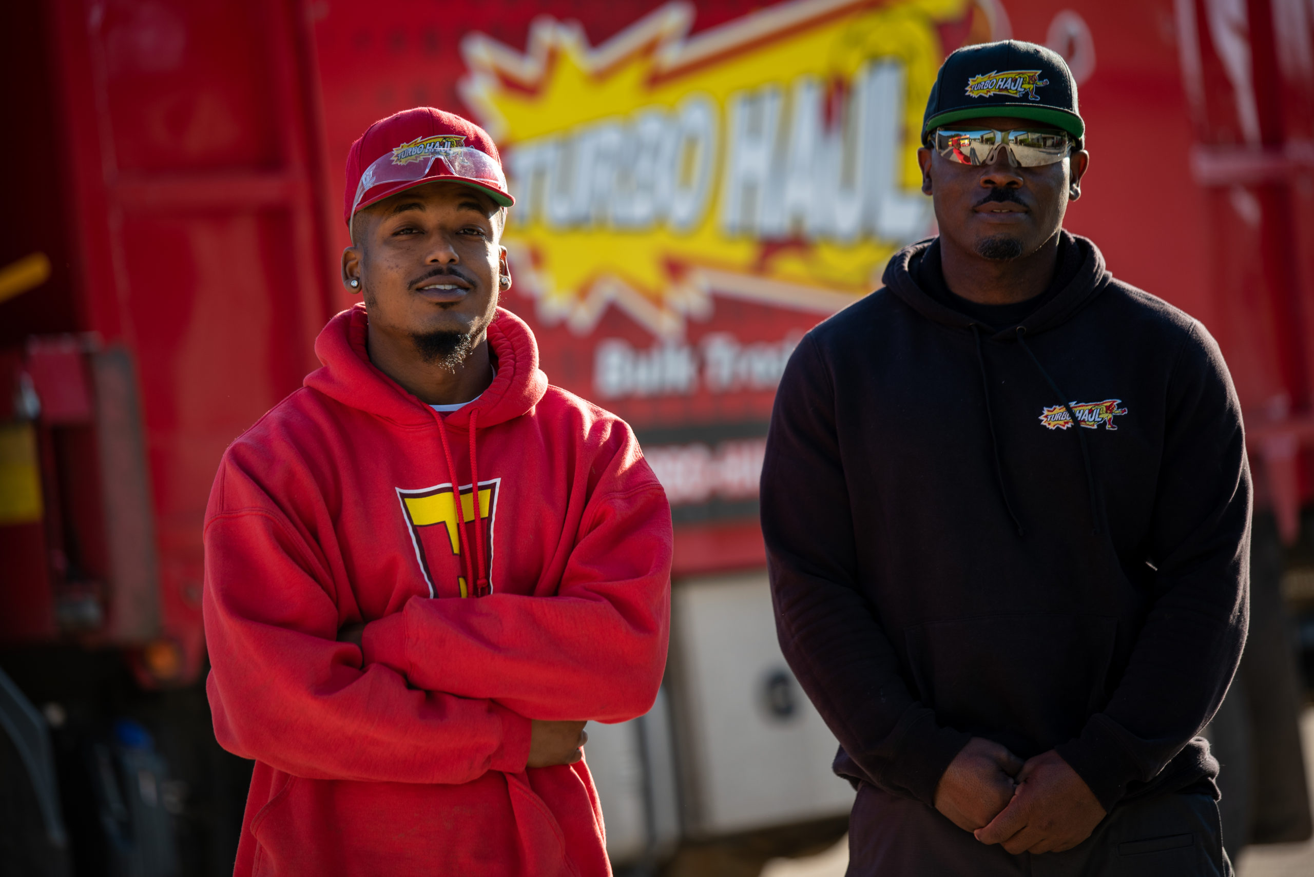 Two junk removal specialists standing in front of a truck in District Heights, MD