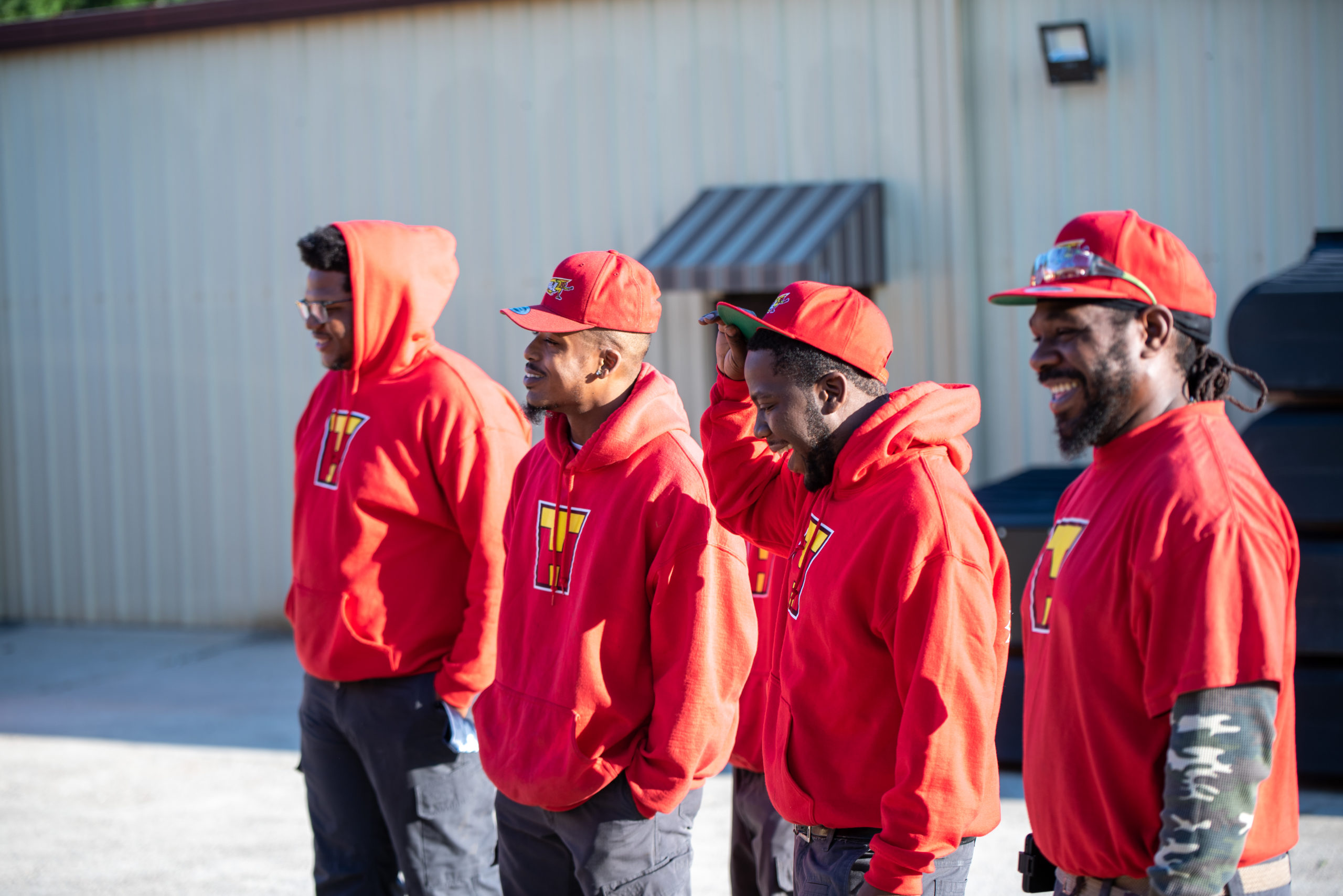 Four TurboHaul employees stand in a line and smile in Cooksville, Maryland