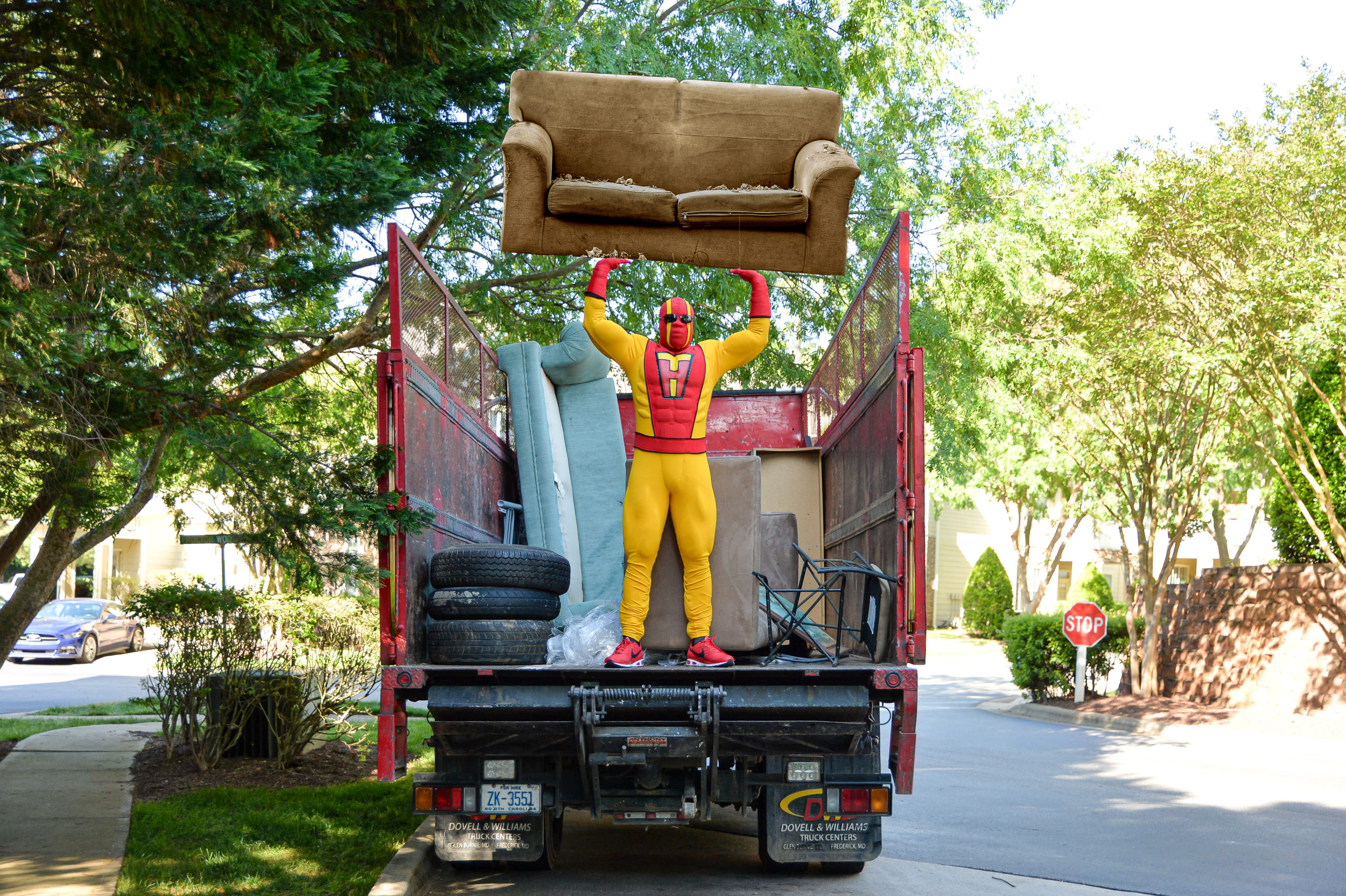 TurboHaul Man holds a couch over his head in the back of a truck in Camp Springs