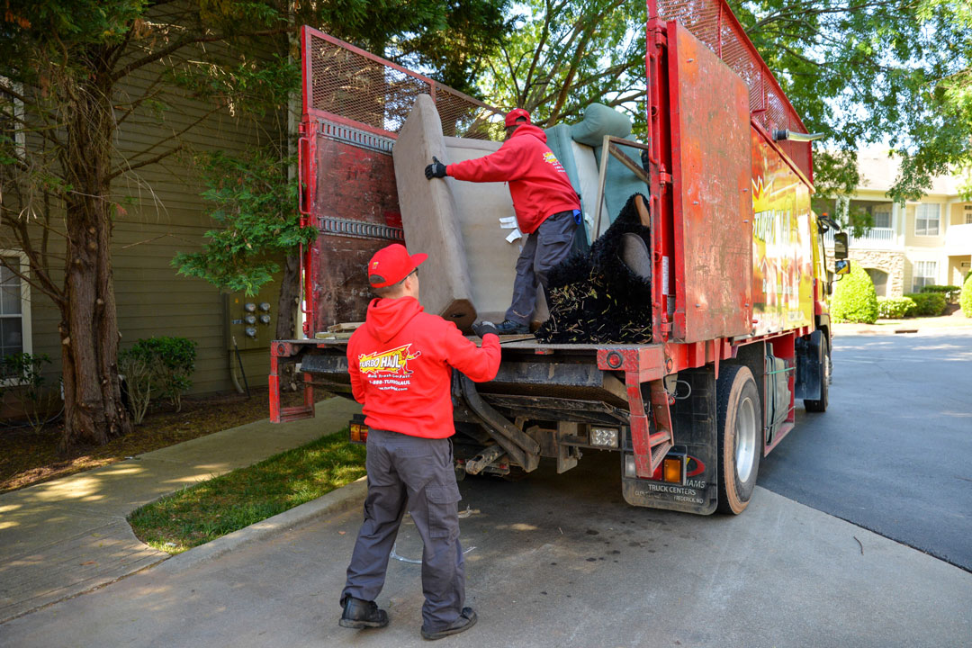 Junk removal specialists completing a trash out service